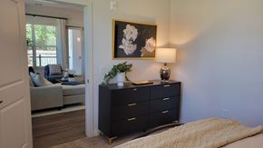 Atlanta apartment for rent - A bedroom with a black dresser and a painting on the wall.