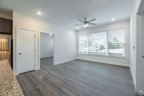 Atlanta apartment for rent - A room with a ceiling fan and a window with blinds.