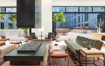 Salt Lake City apartment for rent - A modern living room with a green sofa and a wooden coffee table.