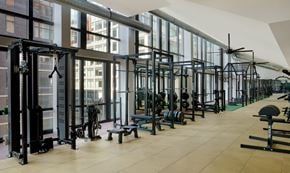 Long Island City apartment for rent - A gym with a variety of equipment including weight machines and free weights.