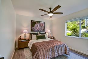Belmont apartment for rent - A bedroom with a bed, nightstands, and a ceiling fan.