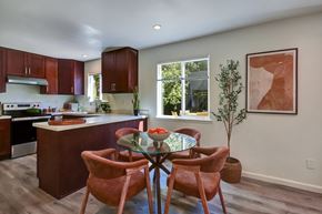 Belmont apartment for rent - A kitchen with a table and chairs in the middle of the room.