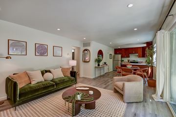 Belmont apartment for rent - A living room with a green couch and a coffee table.