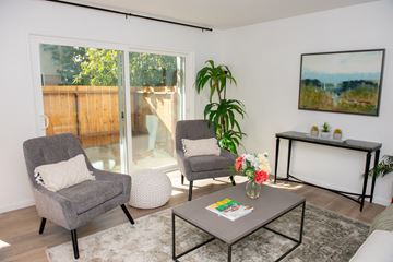 Belmont apartment for rent - a living room with two chairs and a coffee table and a sliding glass patio door
