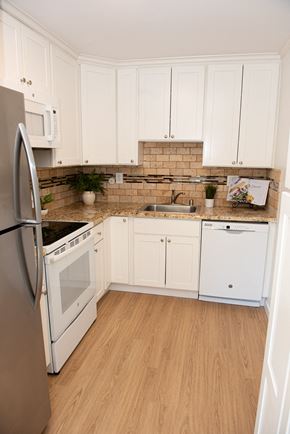 Redwood City apartment for rent - a kitchen with white cabinets and a sink and a refrigerator