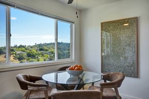 Belmont apartment for rent - A dining room with a glass table and chairs and a view of the outdoors through the window.