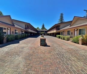 Palo Alto apartment for rent - a courtyard with brick sidewalks and buildings with a fountain