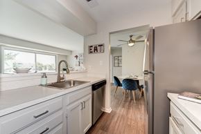 Alexandria apartment for rent - A kitchen with a sink and a refrigerator.