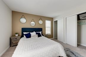 Alexandria apartment for rent - A bedroom with a large bed and a wooden nightstand.