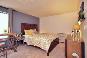 Germantown apartment for rent - A bedroom with a bed, nightstand, and window.
