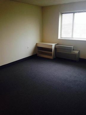 Baltimore apartment for rent - A room with a window and a filing cabinet.