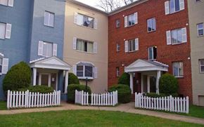 Falls Church apartment for rent - Apartment complex with white picket fences in front of each building.