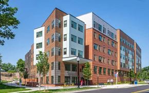 Alexandria apartment for rent - A modern multi-story building with a mix of brick and glass facade.