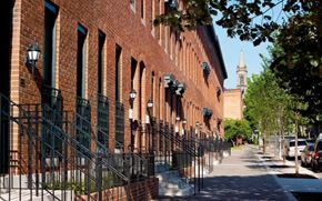 Baltimore apartment for rent - A long brick building with a tower in the background.