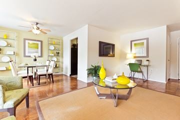 Arlington apartment for rent - A living room with a yellow coffee table and green chairs.