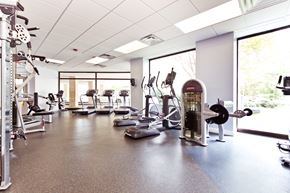 Arlington apartment for rent - A gym with a variety of equipment including treadmills, weights, and exercise machines.