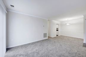 Gaithersburg apartment for rent - A spacious room with a grey carpet and white walls.