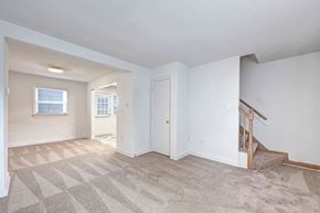 Arlington townhouse for rent - A room with a carpeted floor and a staircase.