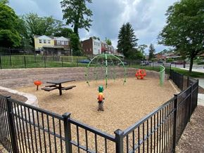 Baltimore City apartment for rent - A playground with a swing set and a sandbox.