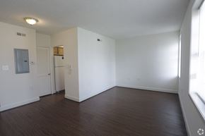 Arlington apartment for rent - an empty living room with a wood floor and white walls