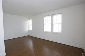 Arlington apartment for rent - the living room of an empty house with white walls and wood floors