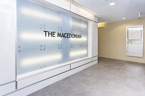 Arlington apartment for rent - A glass wall with the text "THE MACEDONIAN" on it.