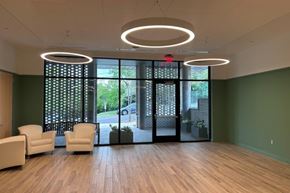 Arlington apartment for rent - A waiting room with a green wall and a wooden floor.