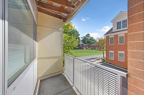 Arlington apartment for rent - A balcony with a metal railing and a glass door.