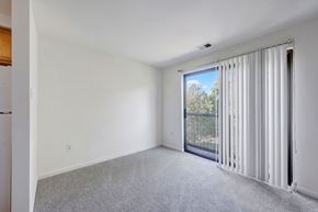 Arlington apartment for rent - A room with a sliding glass door leading to a balcony.