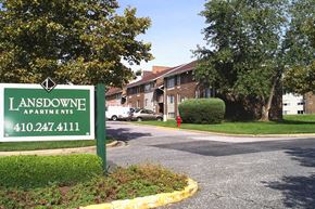 Baltimore apartment for rent - A green sign for Lansdowne Apartments with a phone number on it.