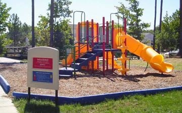 Newport News apartment for rent - A playground with a yellow slide and a sign that says "Welcome".