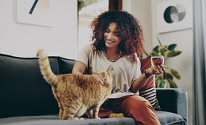 Silver Spring apartment for rent - A woman is sitting on a couch with a cat on her lap.