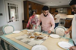 Arlington apartment for rent - A group of people are gathered around a table with plates of food.