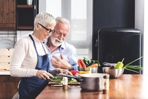 Arlington apartment for rent - An older couple is preparing food together in a kitchen.