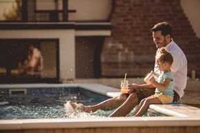 Germantown apartment for rent - A man and a child are sitting by a pool.
