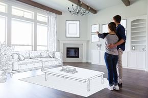 Germantown apartment for rent - A couple is standing in a living room looking at a drawing on the wall.