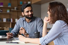 Arlington apartment for rent - A man and a woman are having a conversation over some documents.