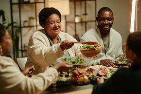 Arlington apartment for rent - A group of people are gathered around a table enjoying a meal together.