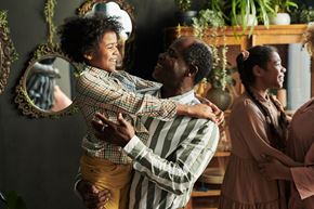 Arlington apartment for rent - A man in a striped shirt is hugging a woman in a brown dress.