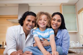 Arlington apartment for rent - A family of three is sitting together in a kitchen.