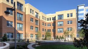 Arlington apartment for rent - A modern building with a curved walkway in front.