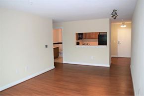 Arlington apartment for rent - A room with wooden floors and a small kitchenette.