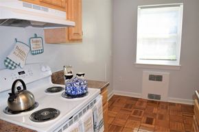 Arlington apartment for rent - A kitchen with a white stove top and a blue and white kettle.