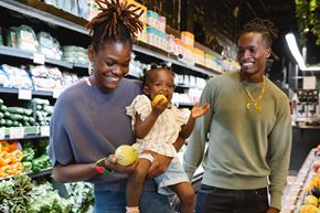 Baltimore apartment for rent - A woman and a man are shopping with a child in a grocery store.