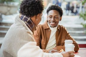Baltimore apartment for rent - Two people sitting at a table, one holding a coffee cup.