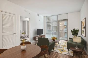 Silver Spring apartment for rent - A living room with a wooden table and green chairs.