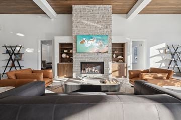 Madison apartment for rent - A modern living room with a fireplace and a painting above it.