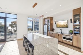 Middleton apartment for rent - a large kitchen with a marble counter top and a door to a balcony