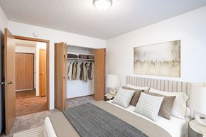 Fargo apartment for rent - A bedroom with a large bed and a painting on the wall. Fargo, ND Candlelight Apartments