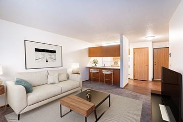 Fargo apartment for rent - A living room with a couch, coffee table, and a painting on the wall.